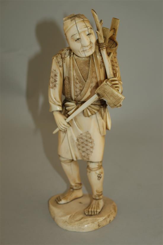 A Japanese sectional ivory figure of a woodsman, early 20th century, 24.5cm